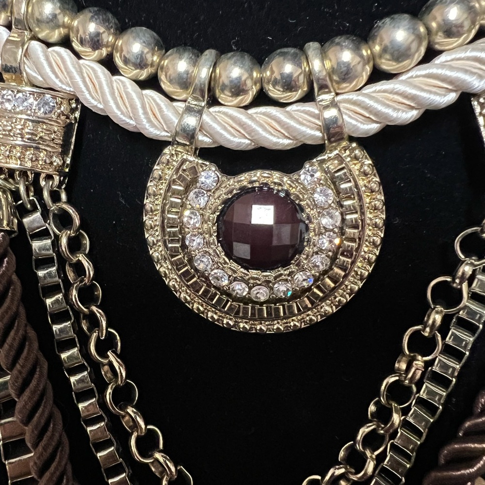 Necklace brown rope with gold, a ruby colored stone surrounded with rhinestone's